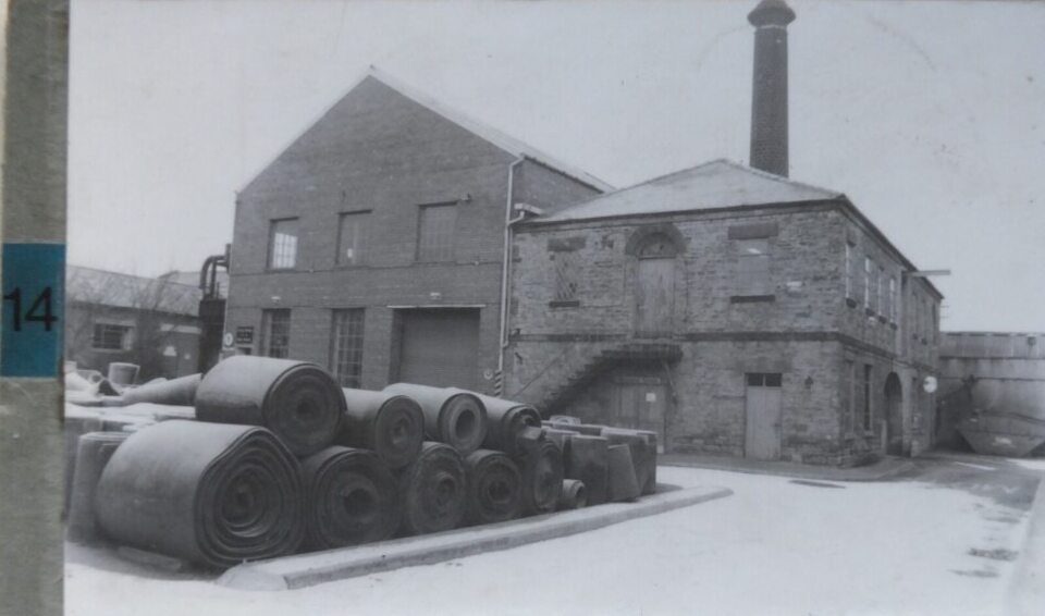 An old building with a tall stone chimney